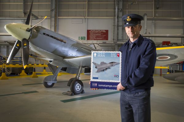 Flight Lieutenant Danny Streames from RAF Lossiemouth, with a Spitfire in the background 