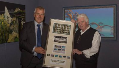 Isle of Man Post Office Chairman presents Roger Dean with a framed set of stamps on opening night of his exhibition at the Manx Museum in Douglas